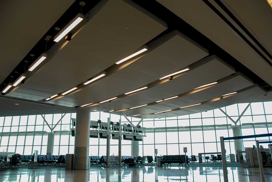 Airport terminal integrated overhead audio speakers